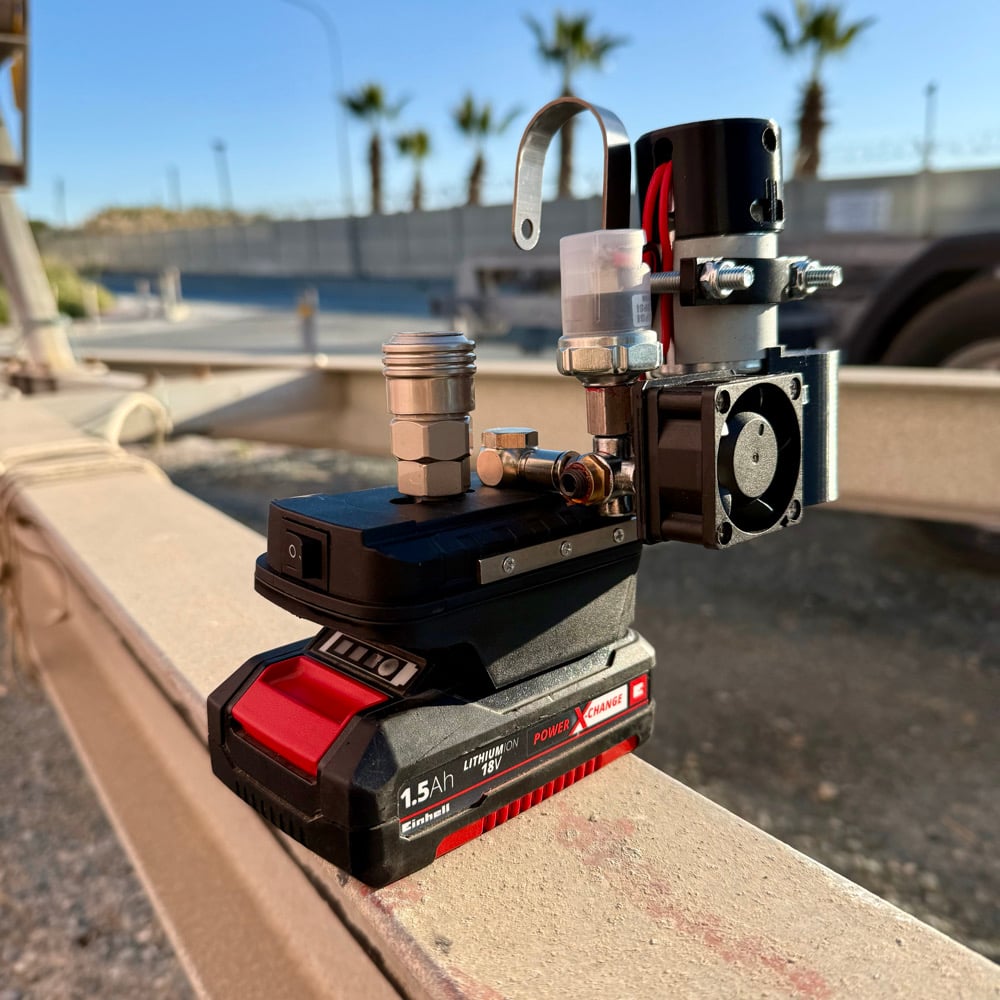 Cordless mini compressor on a red 1.5Ah tool battery