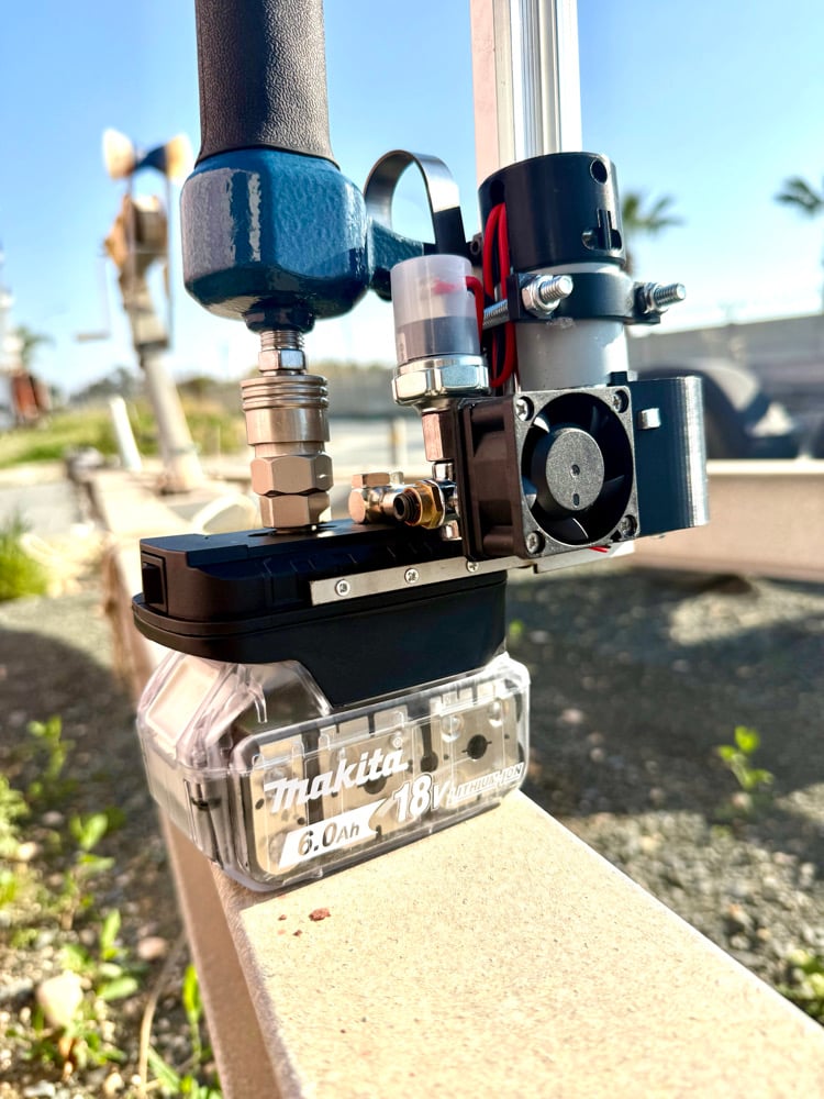 Mini compressor with an air tool attached, running on a Makita 18V 6.0Ah battery