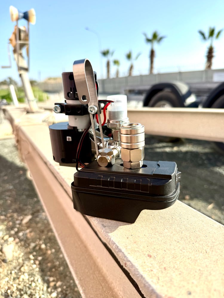 Rear view of the mini compressor showing the metal nail gun bracket