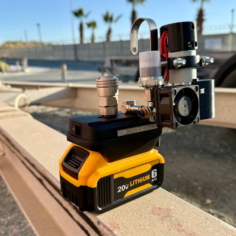 Cordless mini compressor on a yellow 20V lithium battery