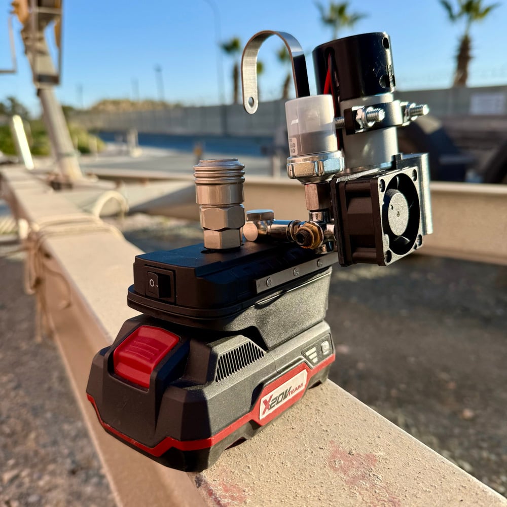 Cordless mini compressor on a red Xcore tool battery
